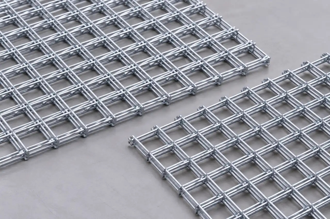 Separate welded mesh panel samples on an inspection surface
