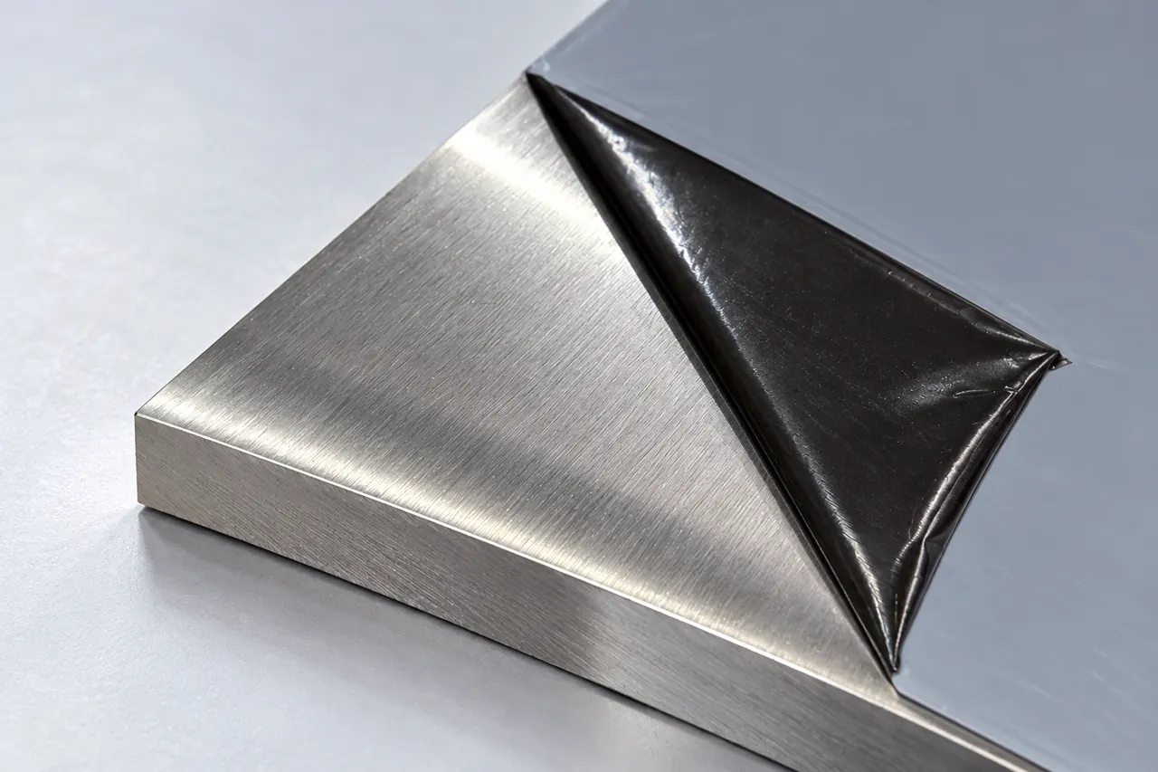 Close view of nickel-alloy plate edge and metallic surface